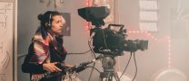 woman filmmaker with production camera