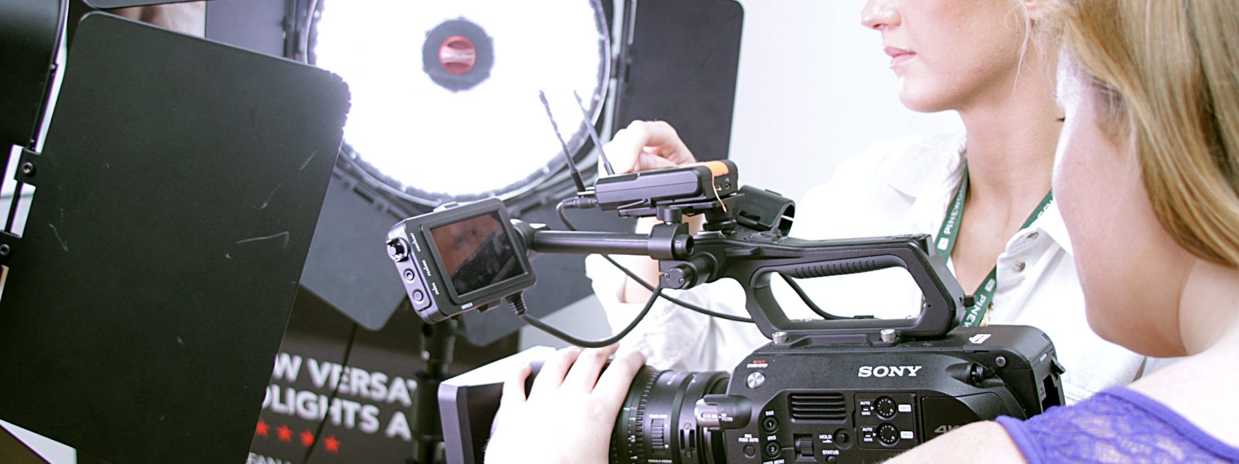Two females operating a camera