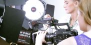 Two females operating a camera